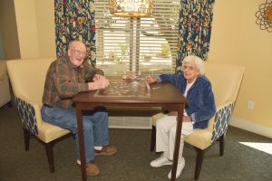 Meet new friends at Independence Court of Quakertown, Enhanced Personal Care, like this caucasian elderly couple putting together a puzzle.