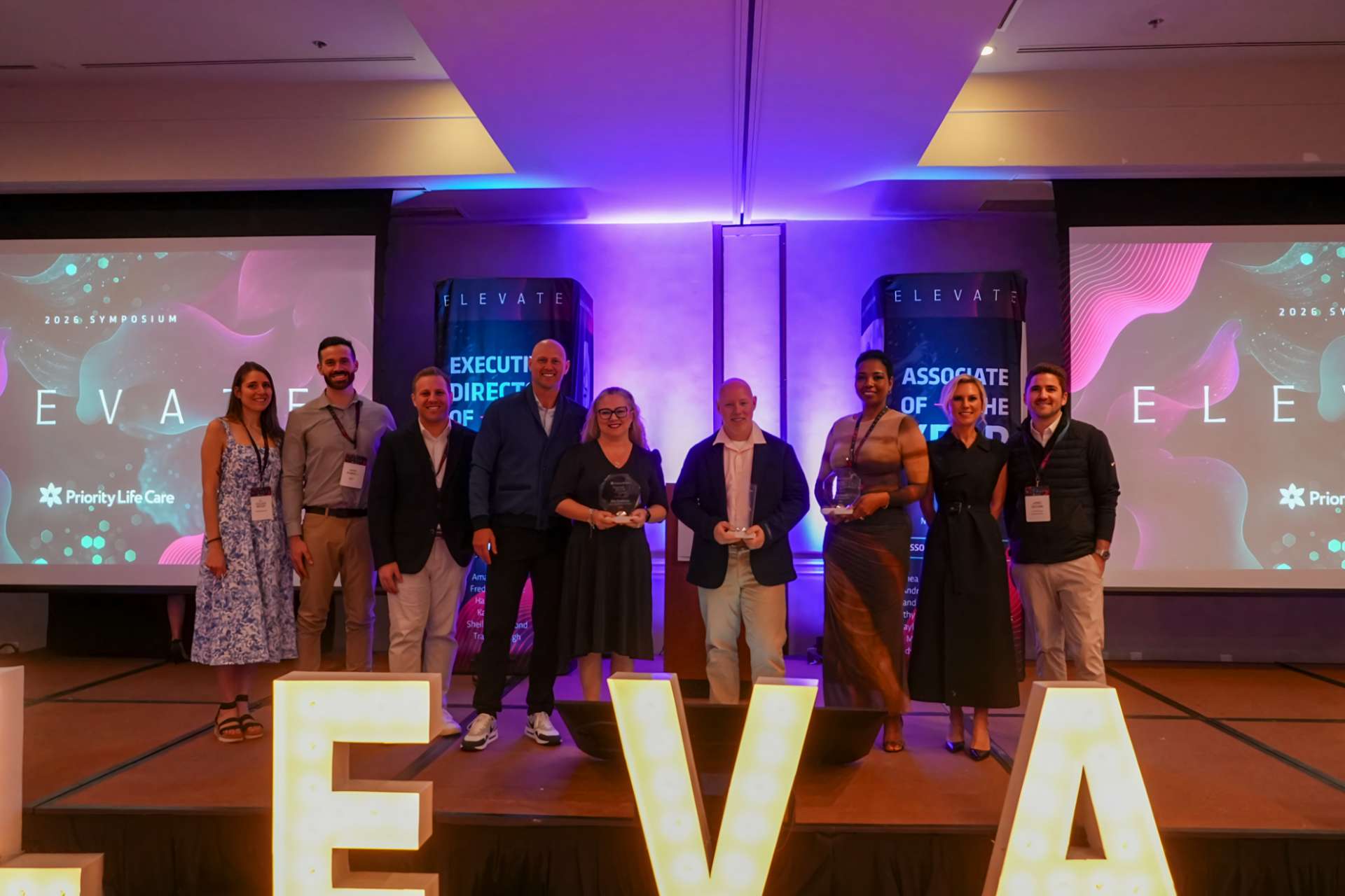 Award Nominees standing together on stage.