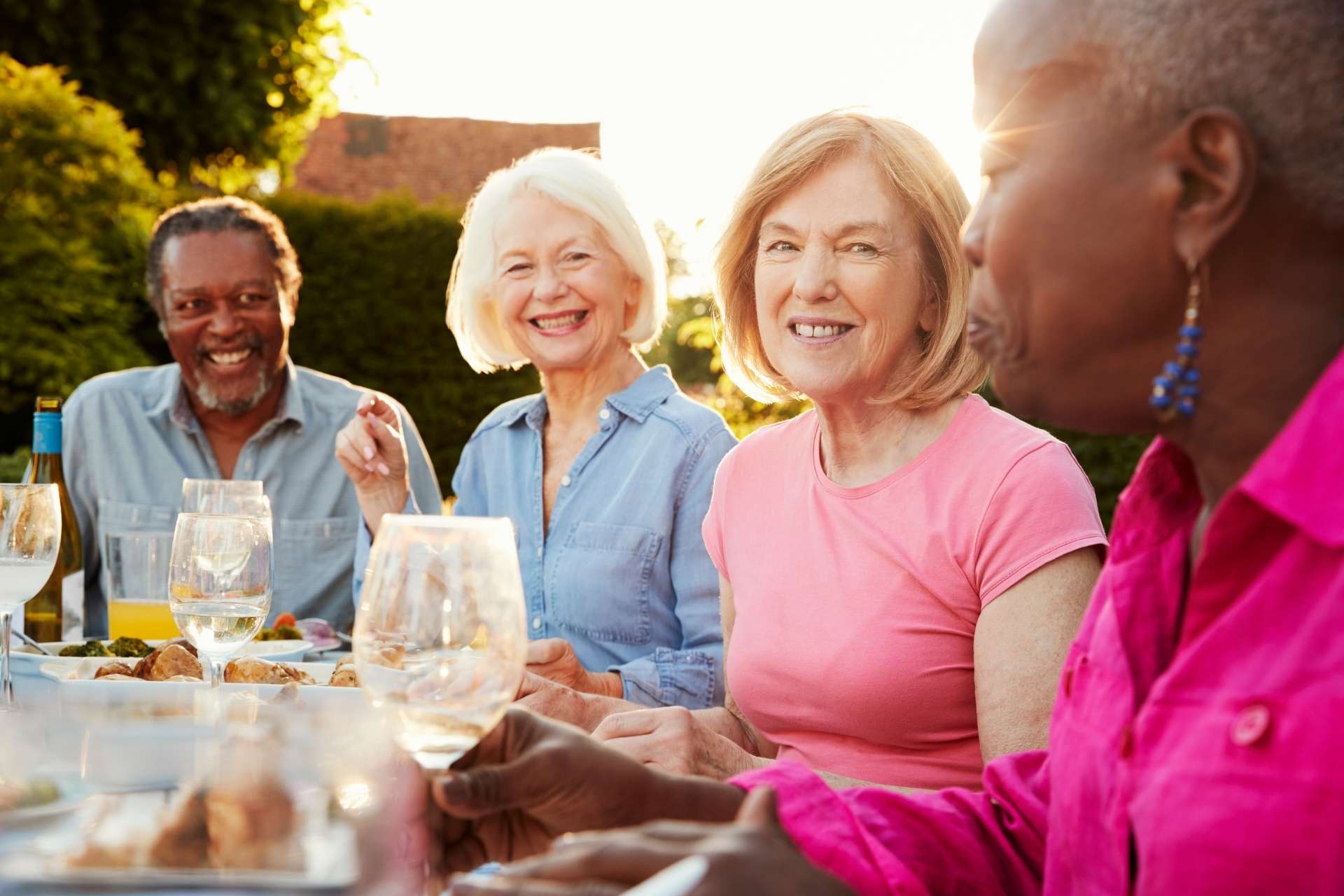 Seniors enjoying a meal together outdoors.